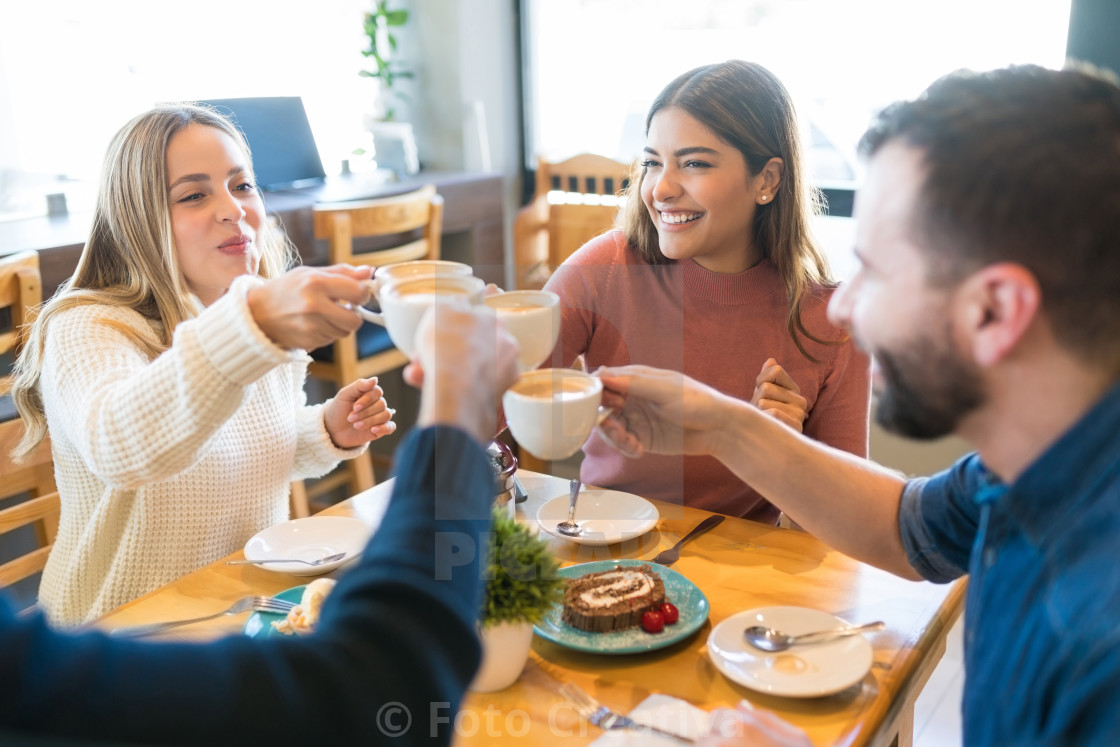 "Happy Friends Celebrating At Cafe" by Foto Creativa - £3.80 "Happy Friends Celebrating At Cafe" stock image