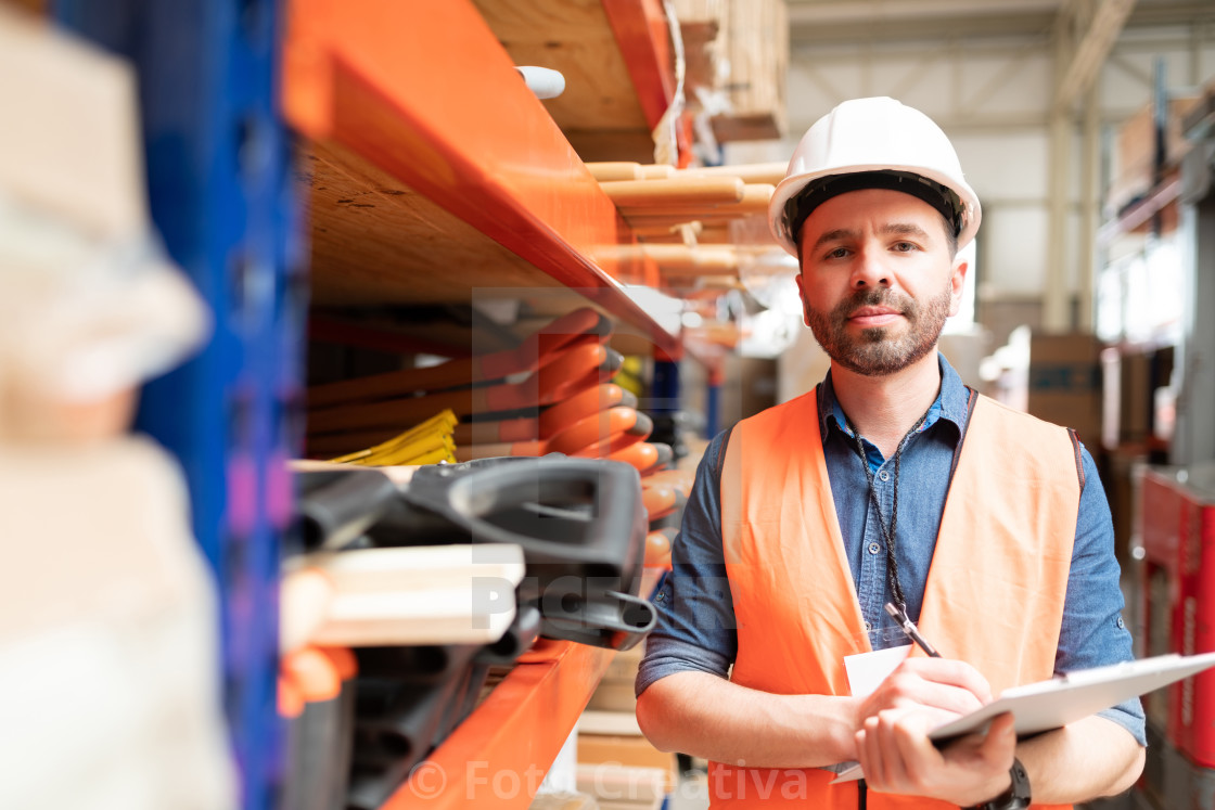 "Good Looking Supervisor Standing With List At Factory" by Foto Creativa - £3.80 "Good Looking Supervisor Standing With List At Factory" stock image