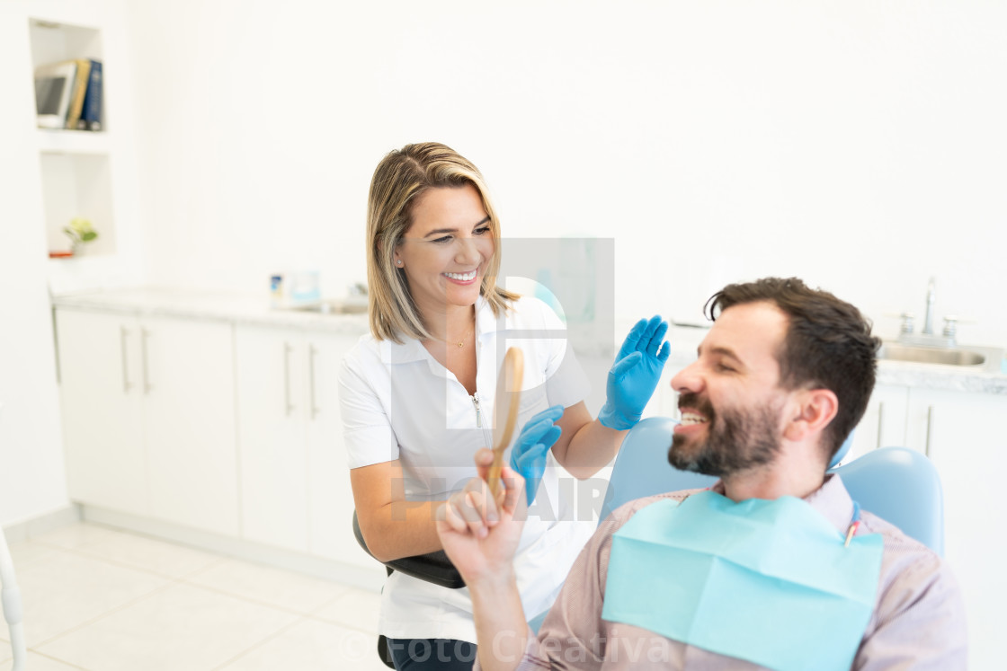 "Smiling Dentist With Patient At Clinic" by Foto Creativa - £3.80 "Smiling Dentist With Patient At Clinic" stock image