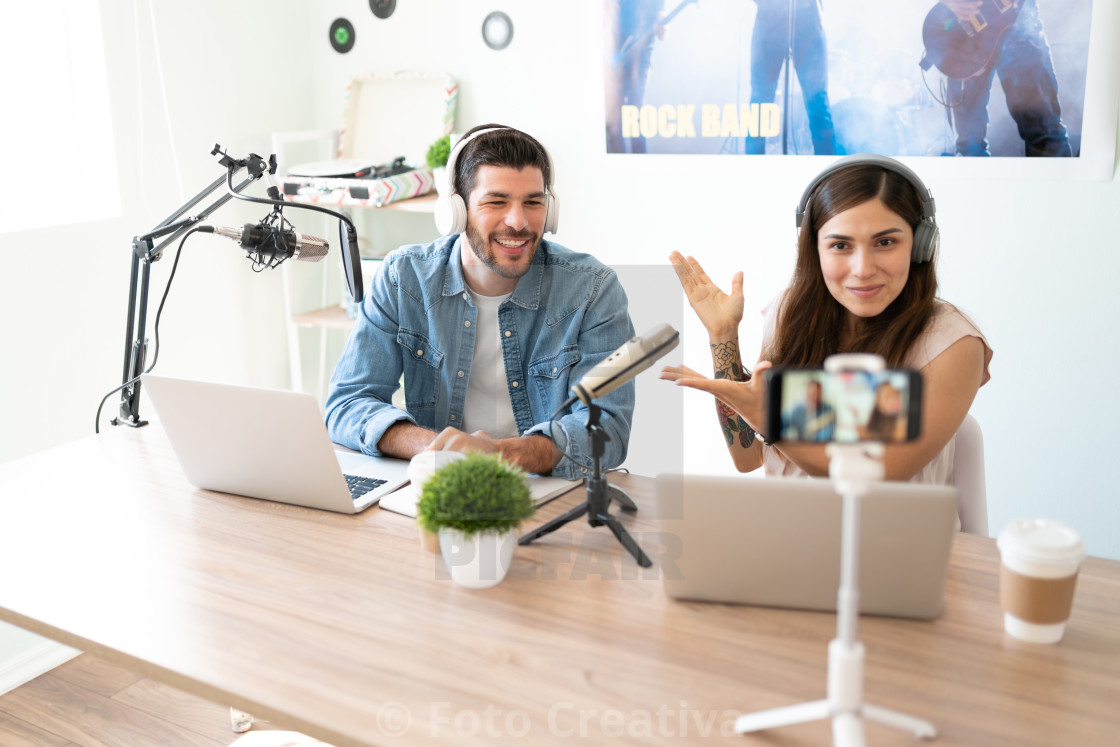 "Announcer introducing her podcast guest" by Foto Creativa - £3.80 "Announcer introducing her podcast guest" stock image