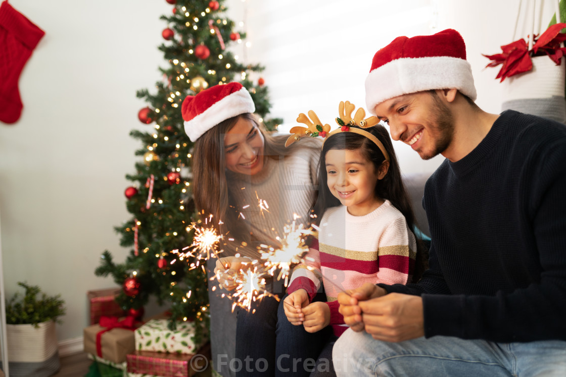 "Hispanic family lighting sparklers at home" by Foto Creativa - £3.80 "Hispanic family lighting sparklers at home" stock image