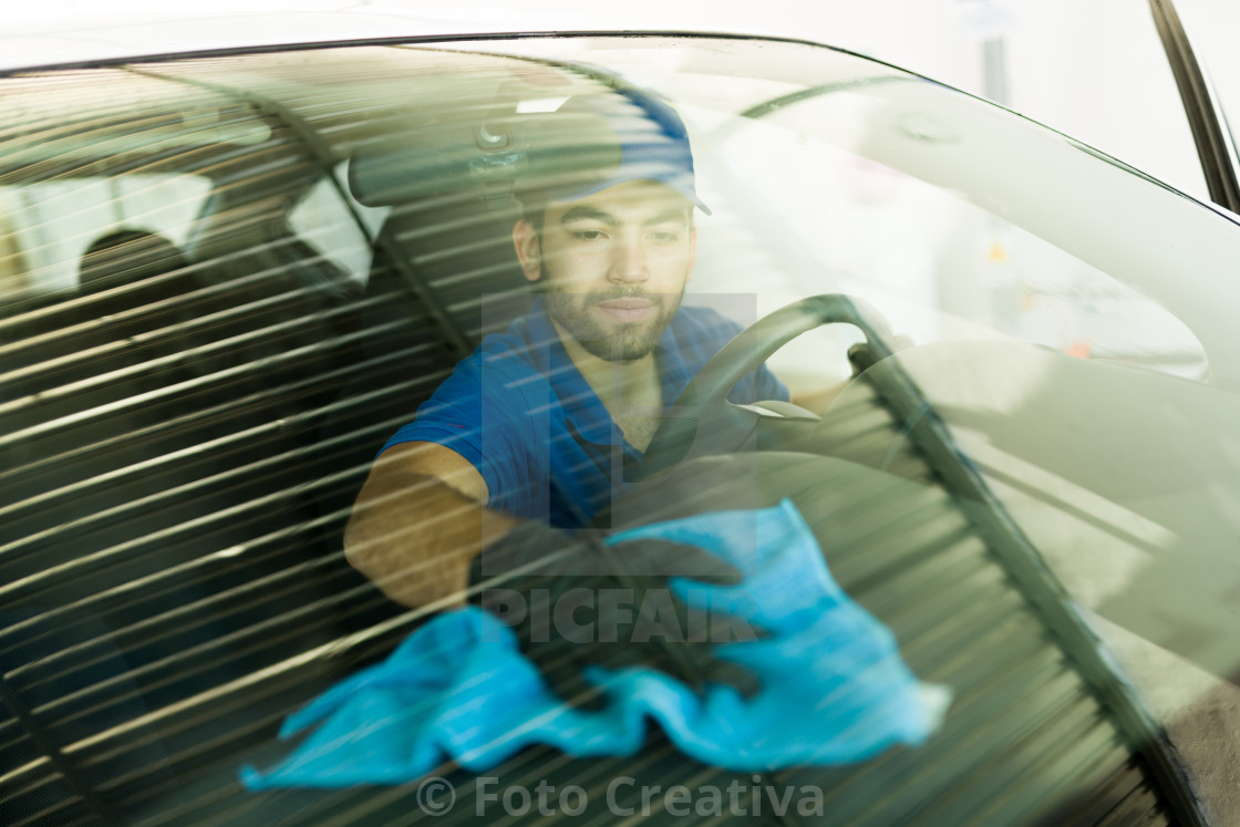 "Employee giving the last details in the car wash" by Foto Creativa - £3.80 "Employee giving the last details in the car wash" stock image