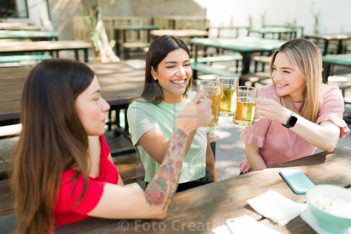 "Beautiful women meeting for drinks at the bar" by Foto Creativa - £3.80 "Beautiful women meeting for drinks at the bar" stock image