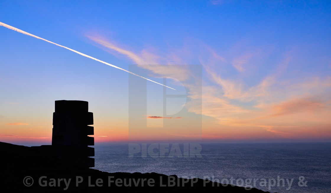 "German WW2 gun emplacement in silhouetted at sunset" stock image