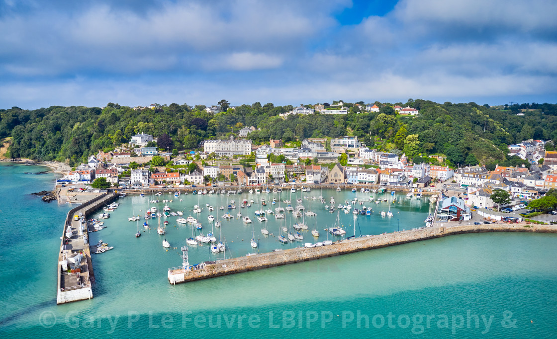 "Aerial drone image of St Aubn's Harbour and Village at high tide in the sunshine. Jersey Channel Islands" stock image