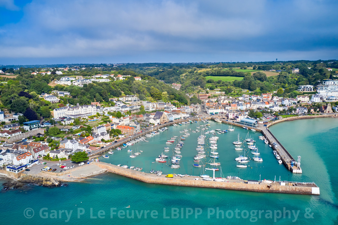 "Aerial drone image of St Aubn's Harbour and Village at high tide in the sunshine. Jersey Channel Islands" stock image