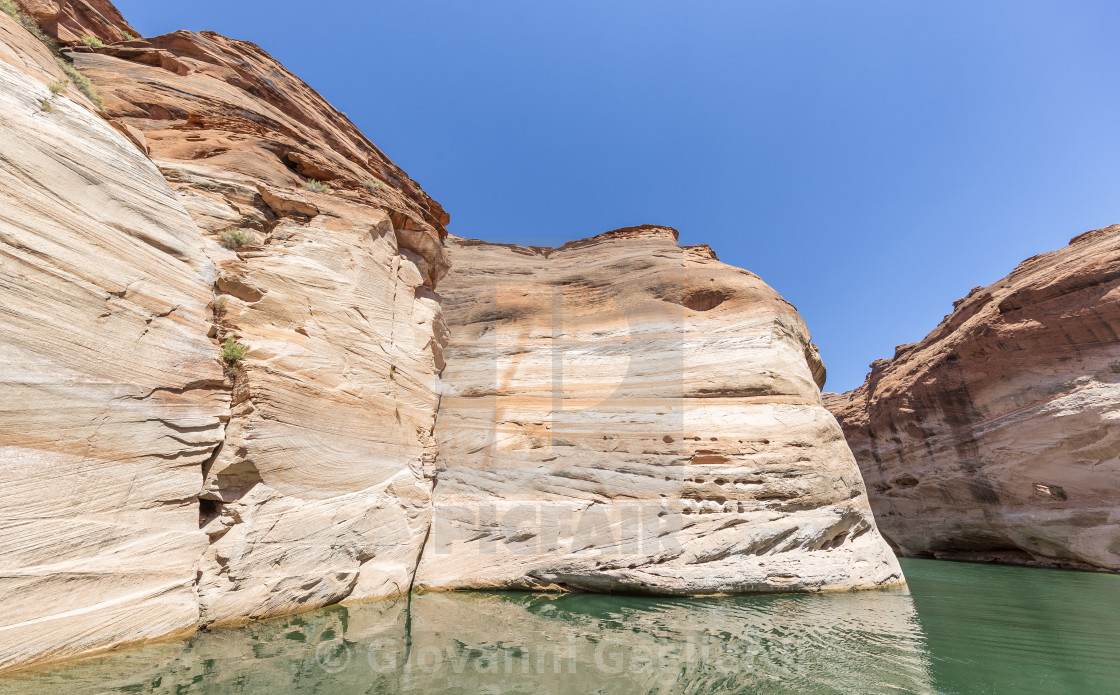 "Lake Powell, Arizona. Narrow cliff-lined canyon from a boat in Glen Canyon..." by Giovanni Gagliardi - $7.68 "Lake Powell, Arizona. Narrow cliff-lined canyon from a boat in Glen Canyon..." stock image