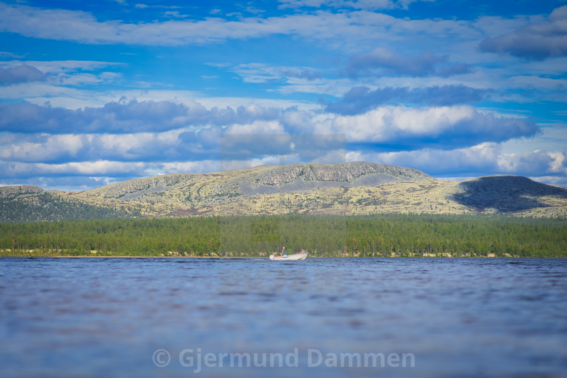 "A man in a boat in the distance on Sølensjøen" by Gjermund Dammen - $44.82 "A man in a boat in the distance on Sølensjøen" stock image