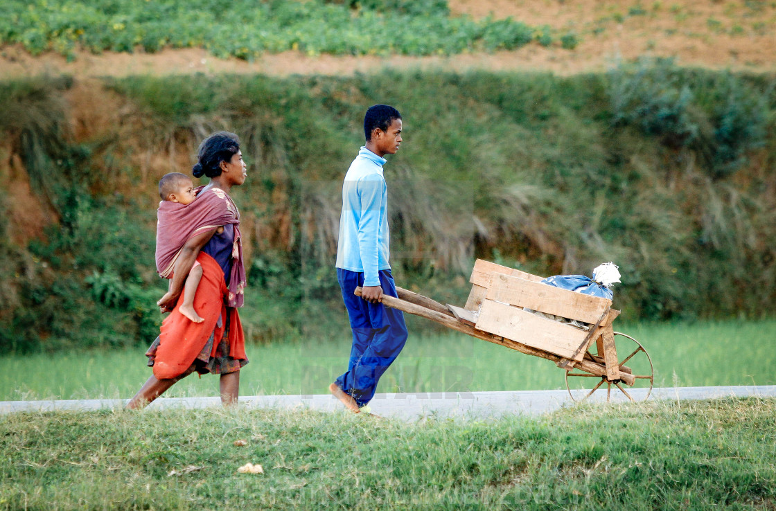 "poor family with wheelbarrow" stock image