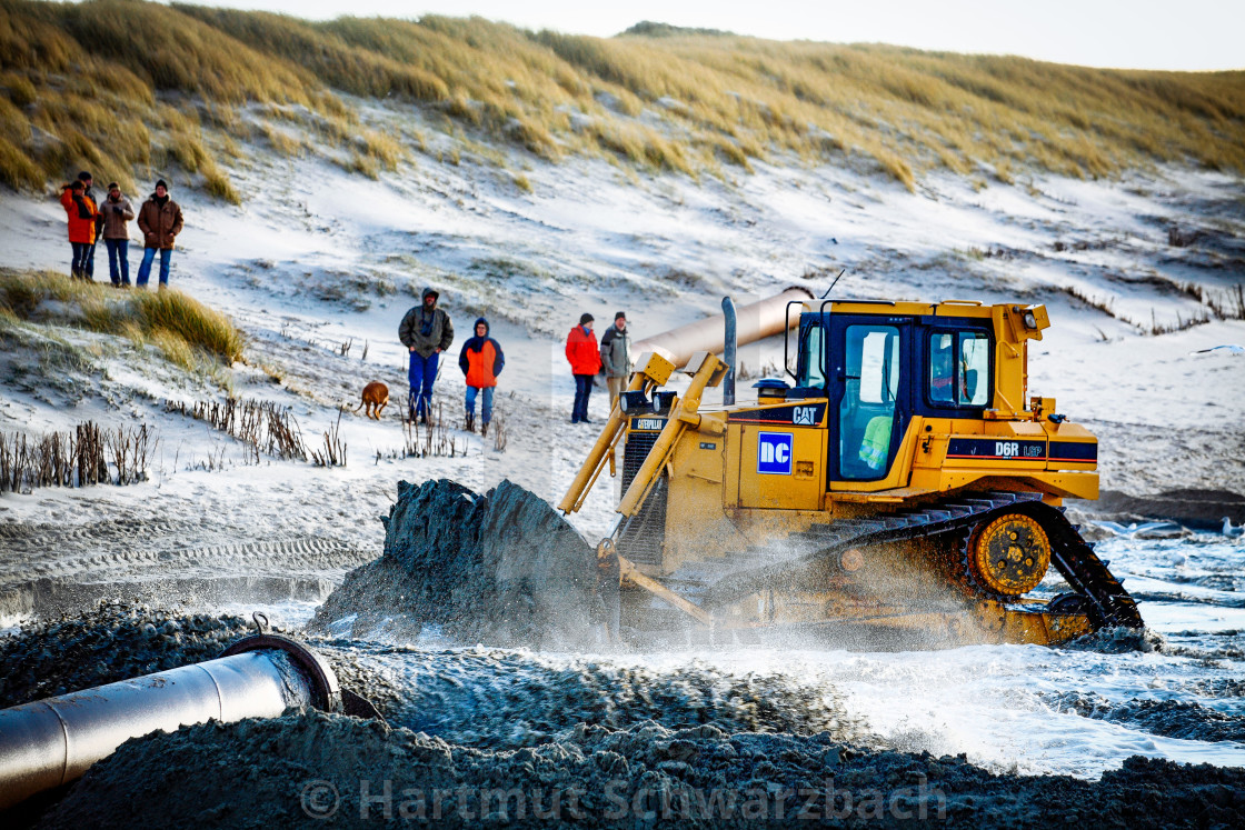 "Sand flushing with heavy equipment to secure the coast and the s" stock image