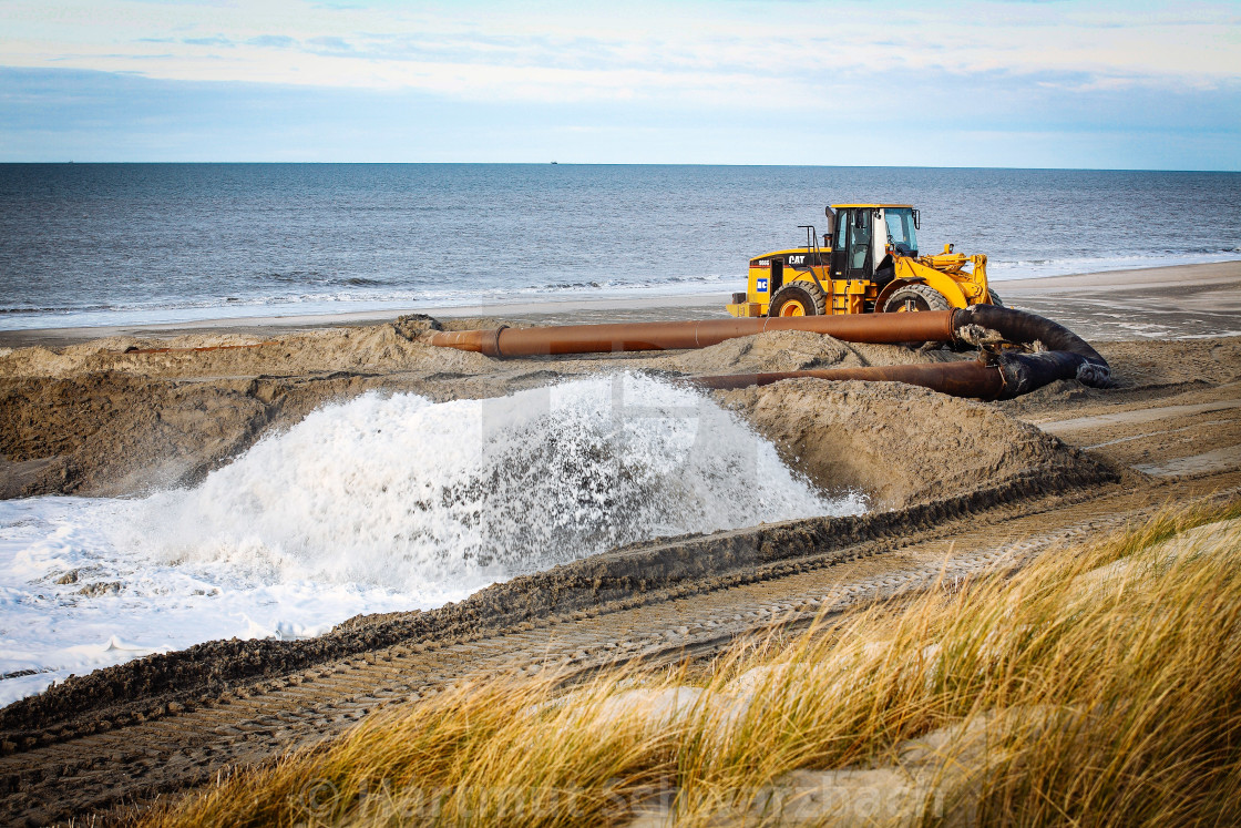 "Sand flushing with heavy equipment to secure the coast and the s" stock image