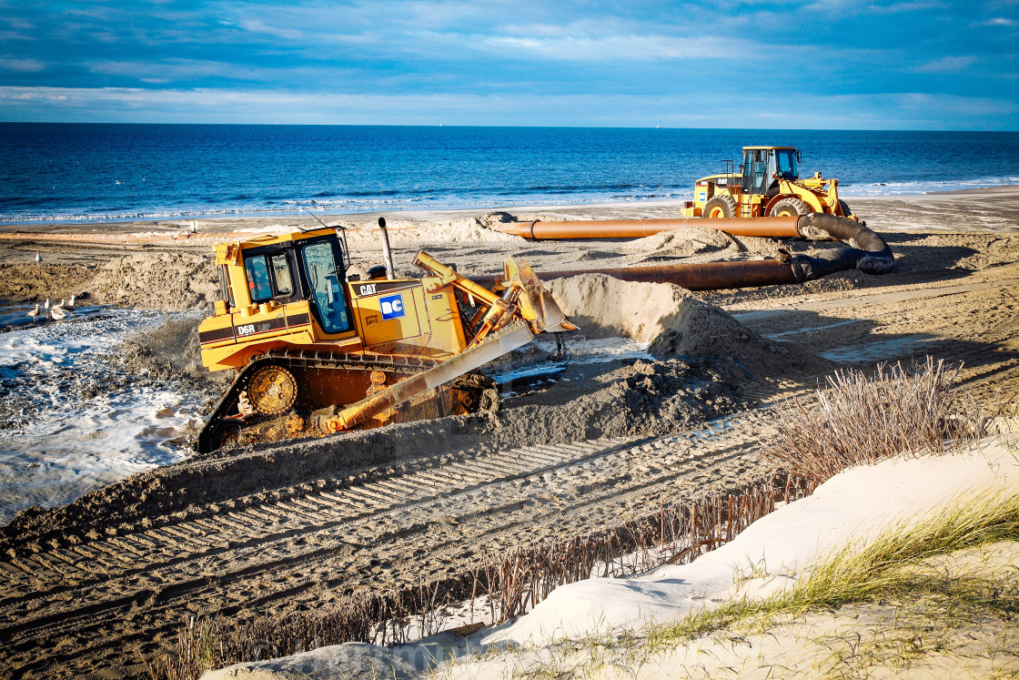 "Sand flushing with heavy equipment to secure the coast and the s" stock image