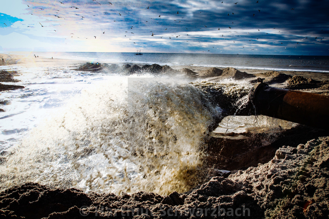 "Sand flushing with heavy equipment to secure the coast and the s" stock image