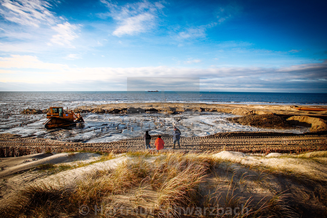 "Sand flushing with heavy equipment to secure the coast and the s" stock image