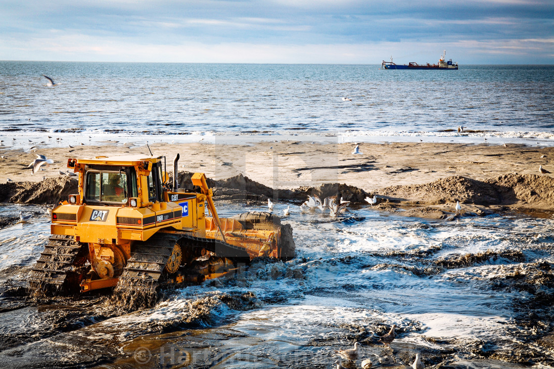 "Sand flushing with heavy equipment to secure the coast and the s" stock image