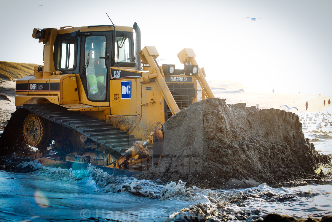 "Sand flushing with heavy equipment to secure the coast and the s" stock image