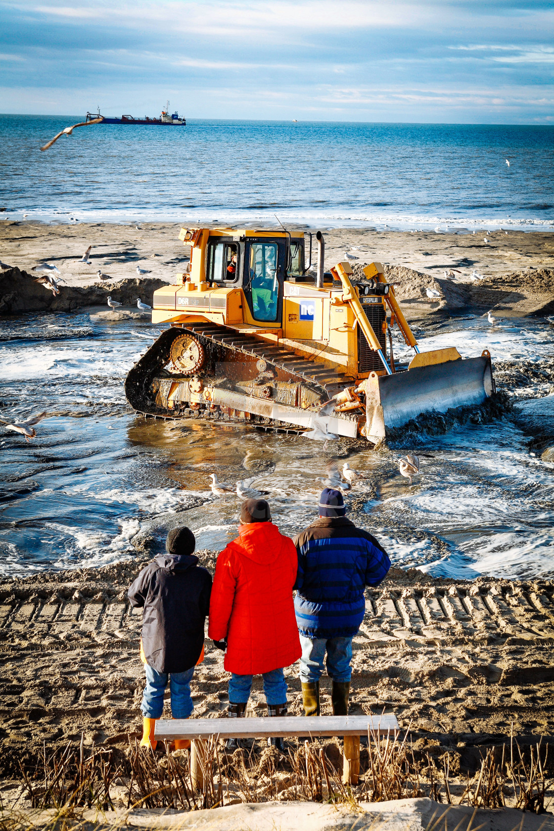 "Sand flushing with heavy equipment to secure the coast and the s" stock image