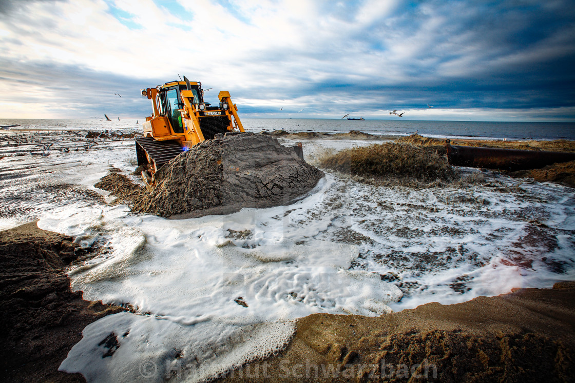 "Sand flushing with heavy equipment to secure the coast and the s" stock image