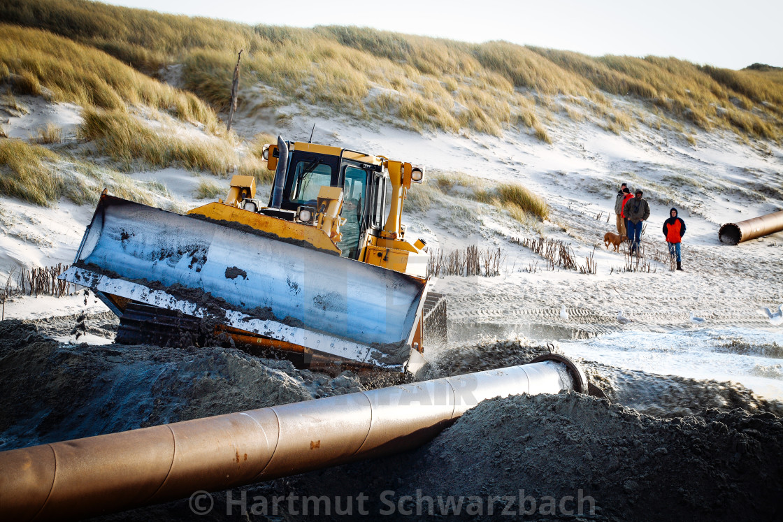 "Sand flushing with heavy equipment to secure the coast and the s" stock image