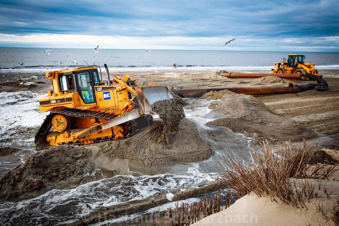 "Sand flushing with heavy equipment to secure the coast and the s" stock image