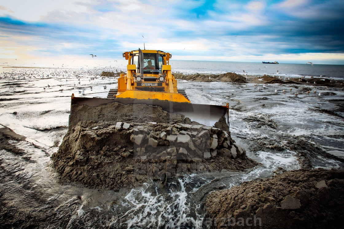 "Sand flushing with heavy equipment to secure the coast and the s" stock image