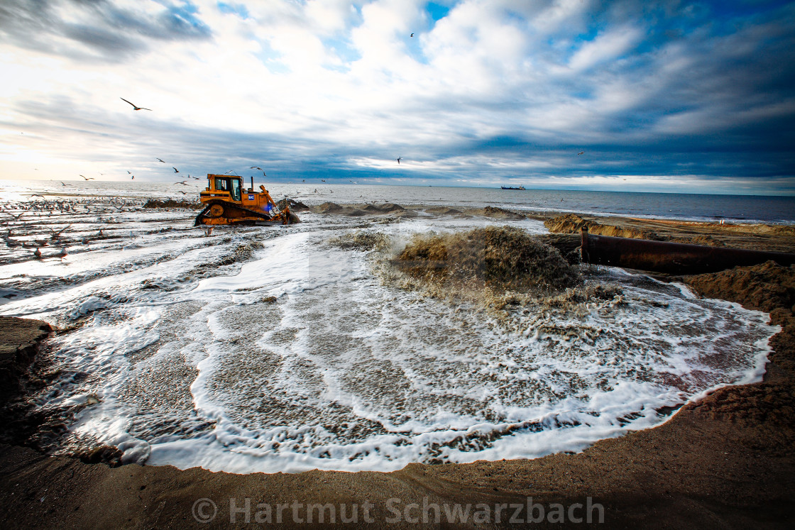 "Sand flushing with heavy equipment to secure the coast and the s" stock image