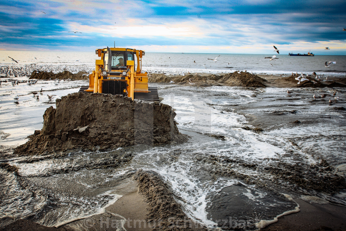 "Sand flushing with heavy equipment to secure the coast and the s" stock image