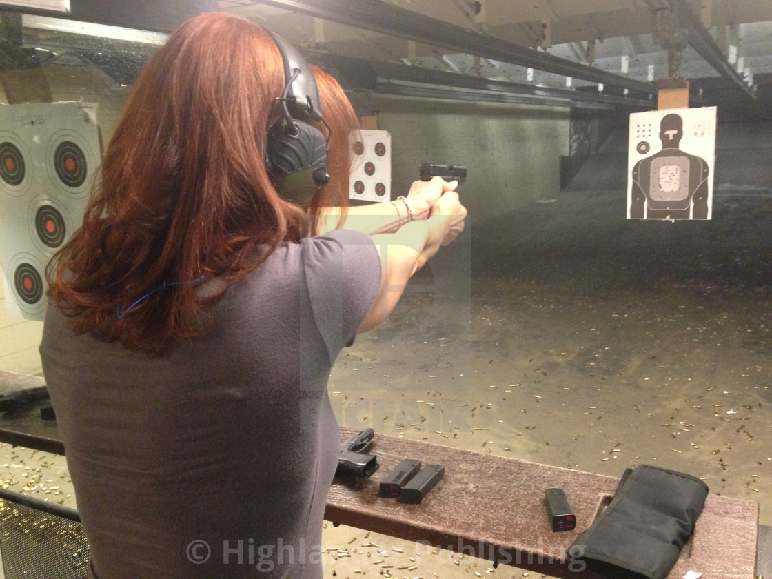 "Woman Shooting Handgun" by Highlander Publishing - $12.61 "Woman Shooting Handgun" stock image
