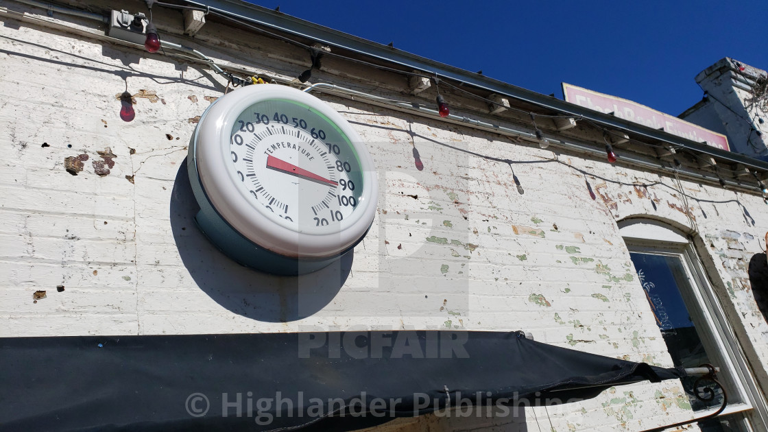 "Vintage temperature gauge on old wall" stock image