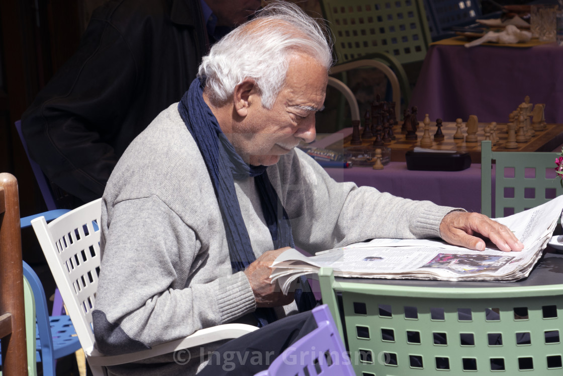 "Older Italian gentleman reading paper" stock image