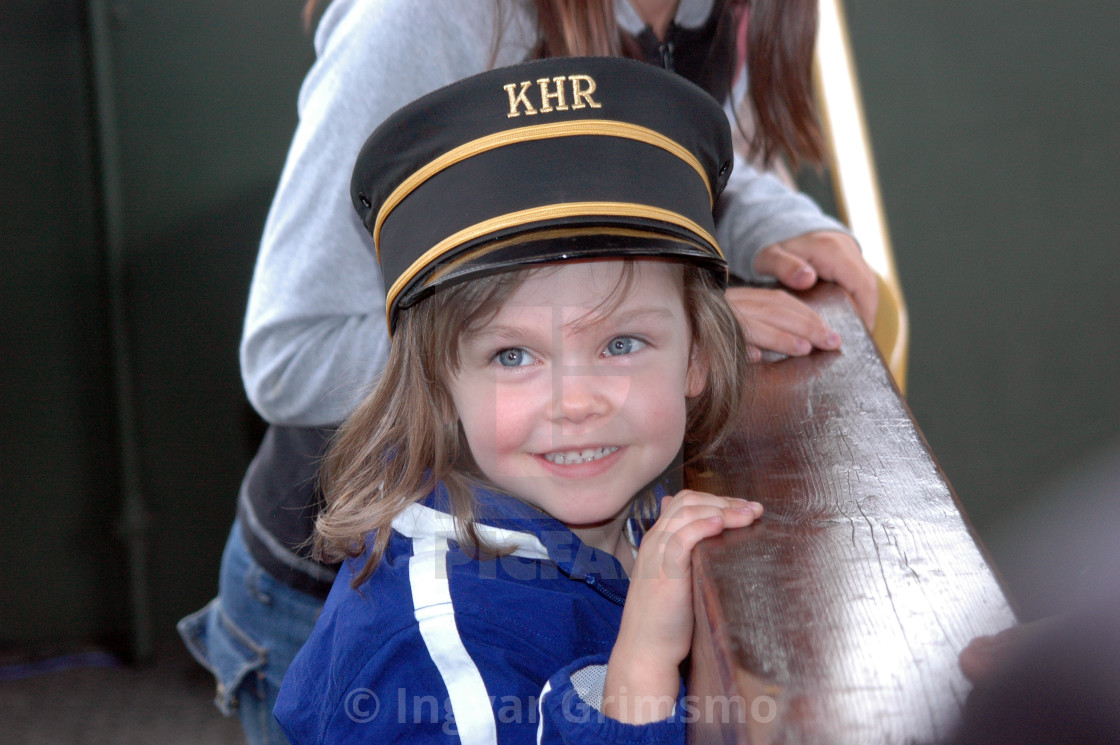 "Girl on train with a railroad hat" by Ingvar Grimsmo - $12.70 "Girl on train with a railroad hat" stock image