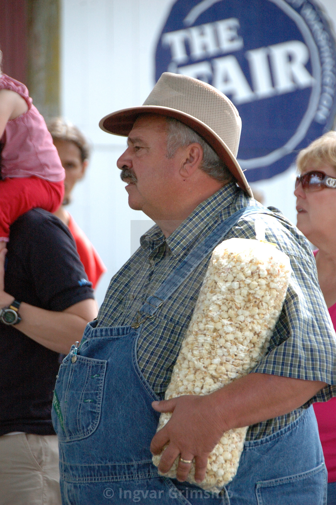 "County fair goer enjoying popcorn" by Ingvar Grimsmo - $12.70 "County fair goer enjoying popcorn" stock image