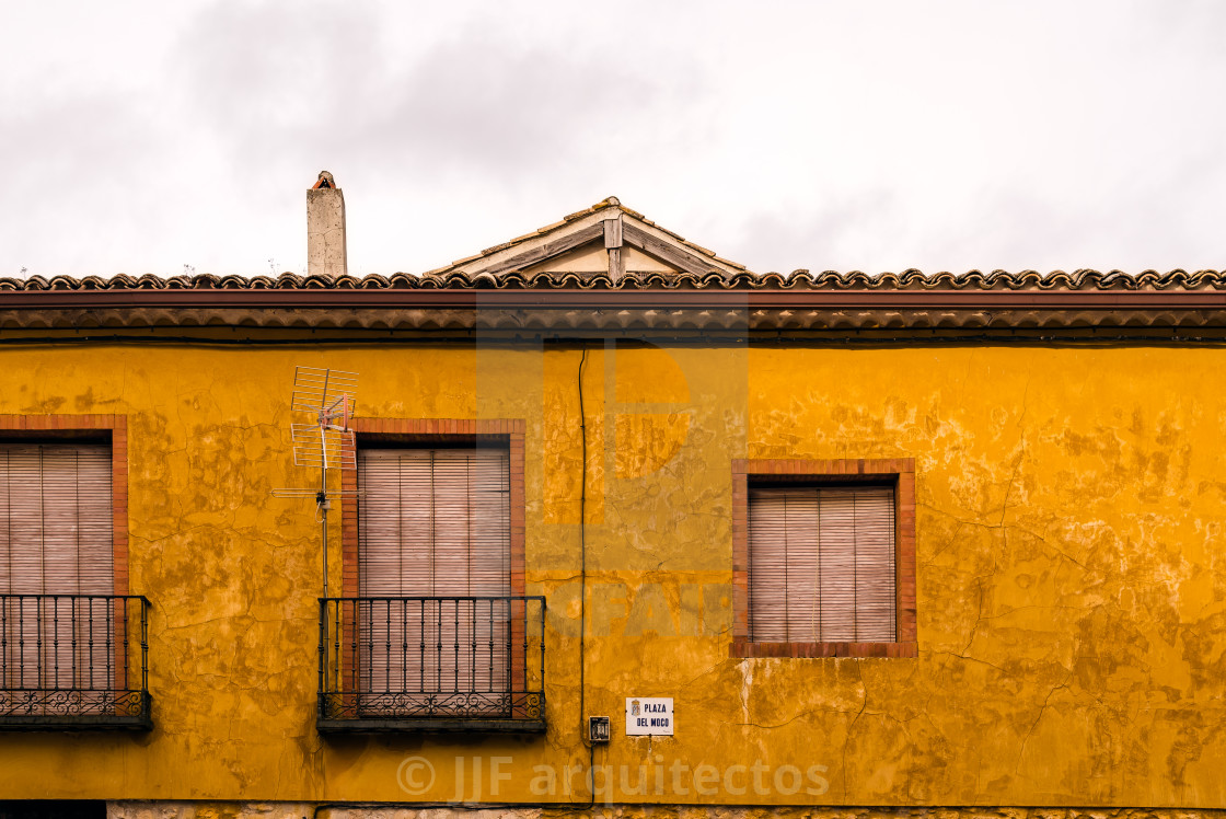 "Traditional house with windows and balconies and a yellow plastered facade" stock image