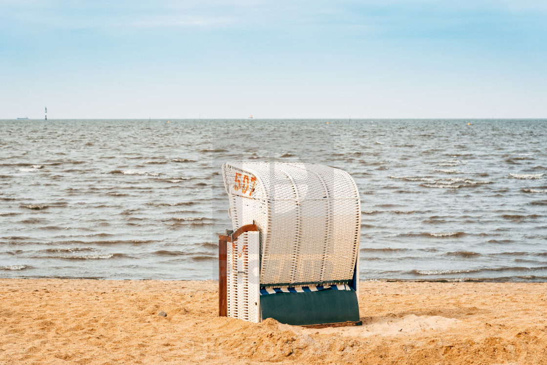 "Sandy beach and typical hooded beach chairs in Cuxhaven in the North Sea coast" stock image