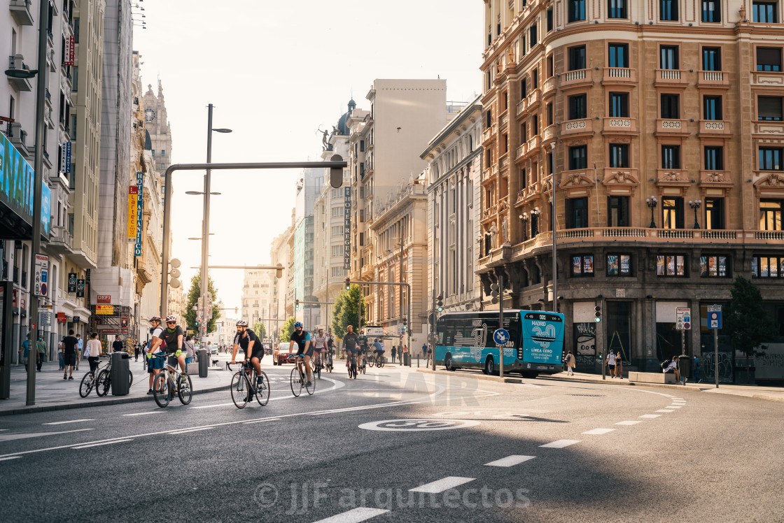 "Cyclists riding on an empty Gran Via Avenue during Covid-19 pandemic lockdown in Madrid" stock image