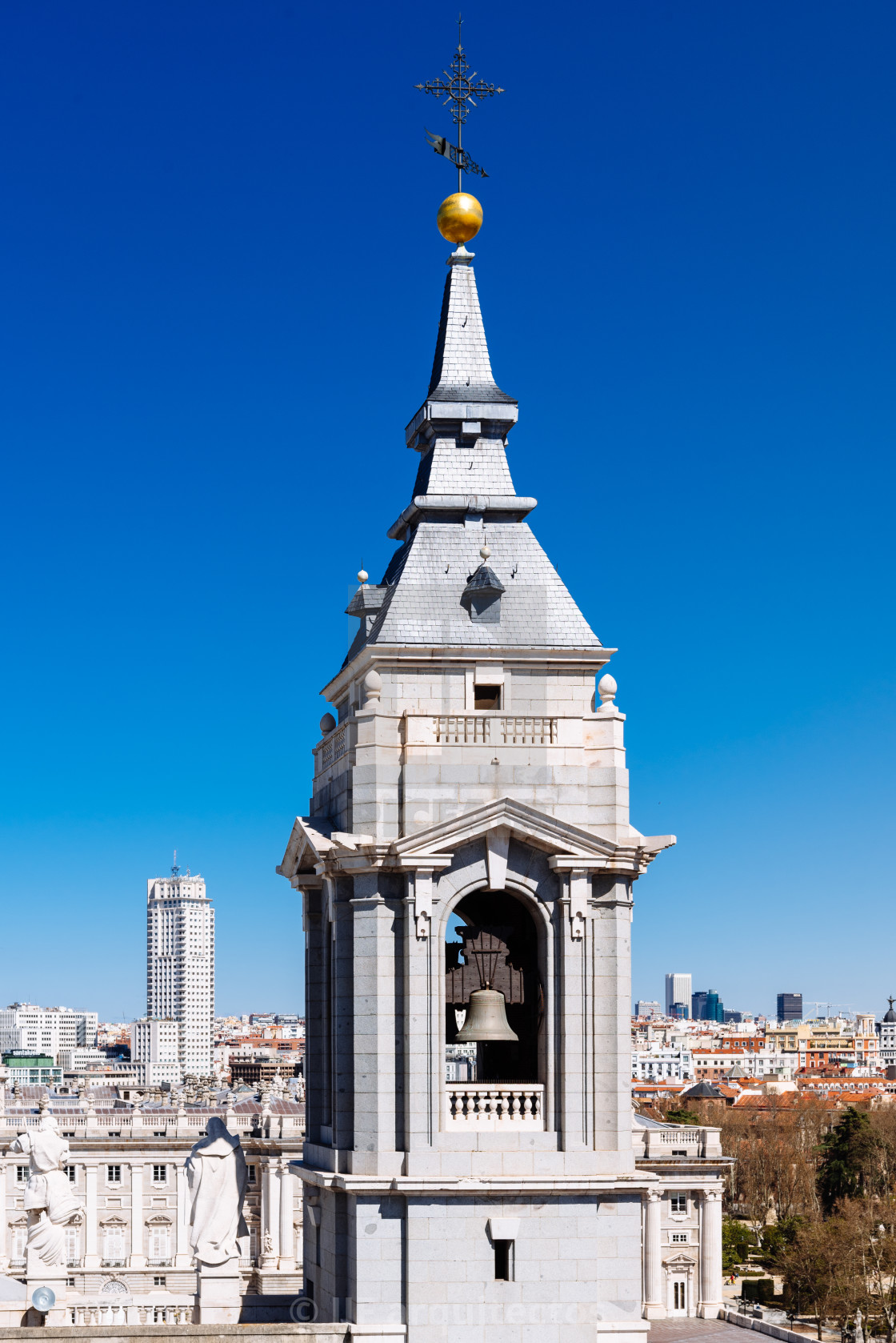 "Close-up of the belfry of the Cathedral of Madrid against cityscape" stock image