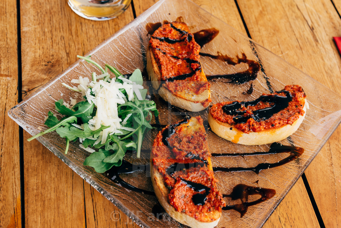 "Homemade Italian Focaccia with Rocket Salad, Tomatoes, and Parmesan Cheese" stock image