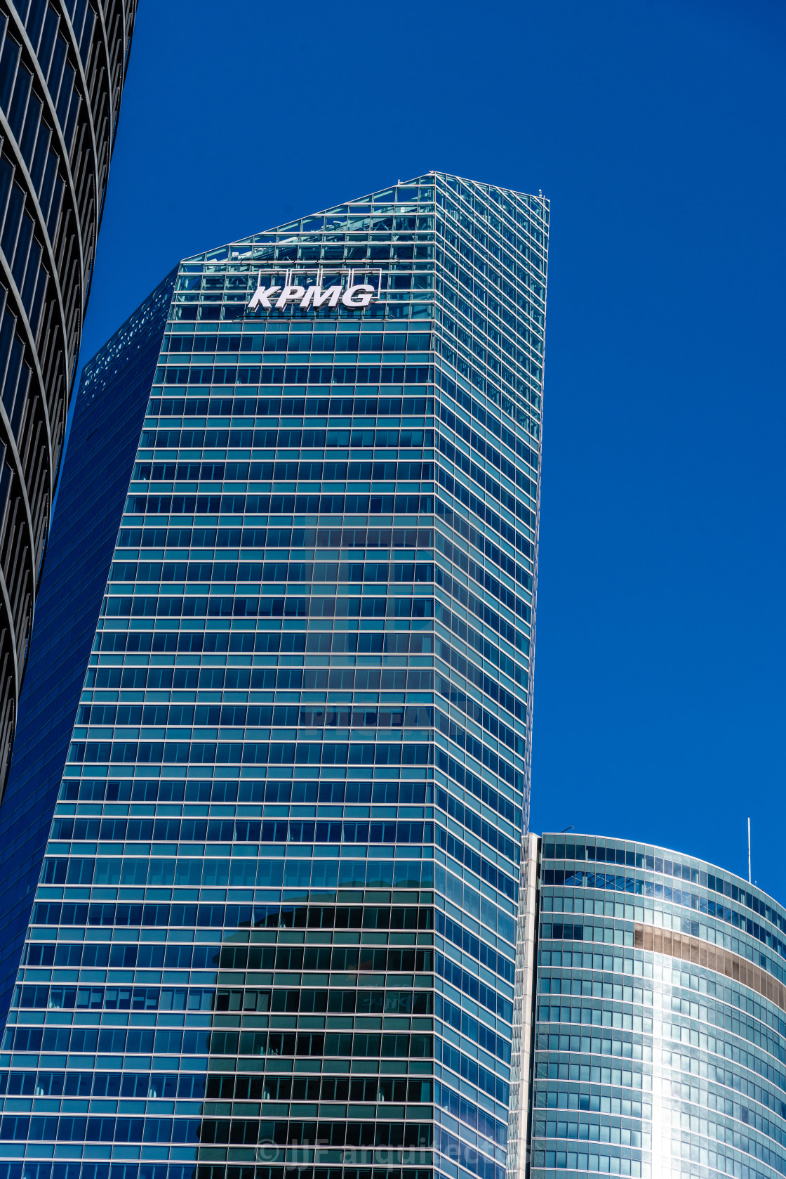 "Low angle view of KPMG Tower in Cuatro Torres financial district in Madrid" stock image