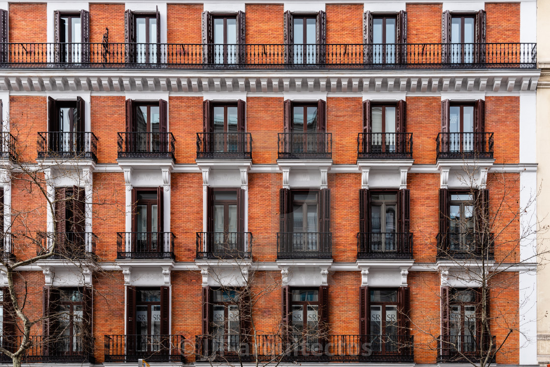 "Elevation View of Old Luxury Residential Building with Brick Facade and Balconies" stock image