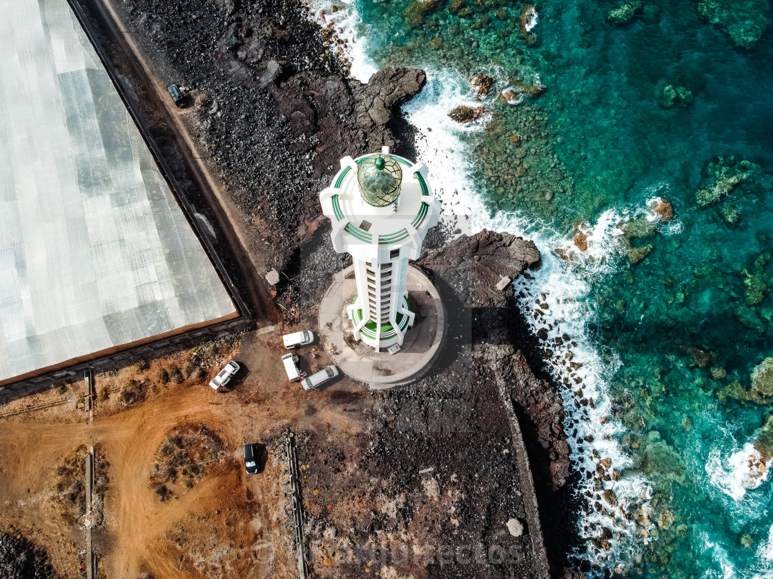 "Aerial top view of lighthouse, rocks and ocean waves in a volcanic landscape" stock image