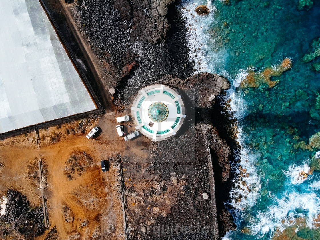 "Aerial top view of lighthouse, rocks and ocean waves in a volcanic landscape" stock image