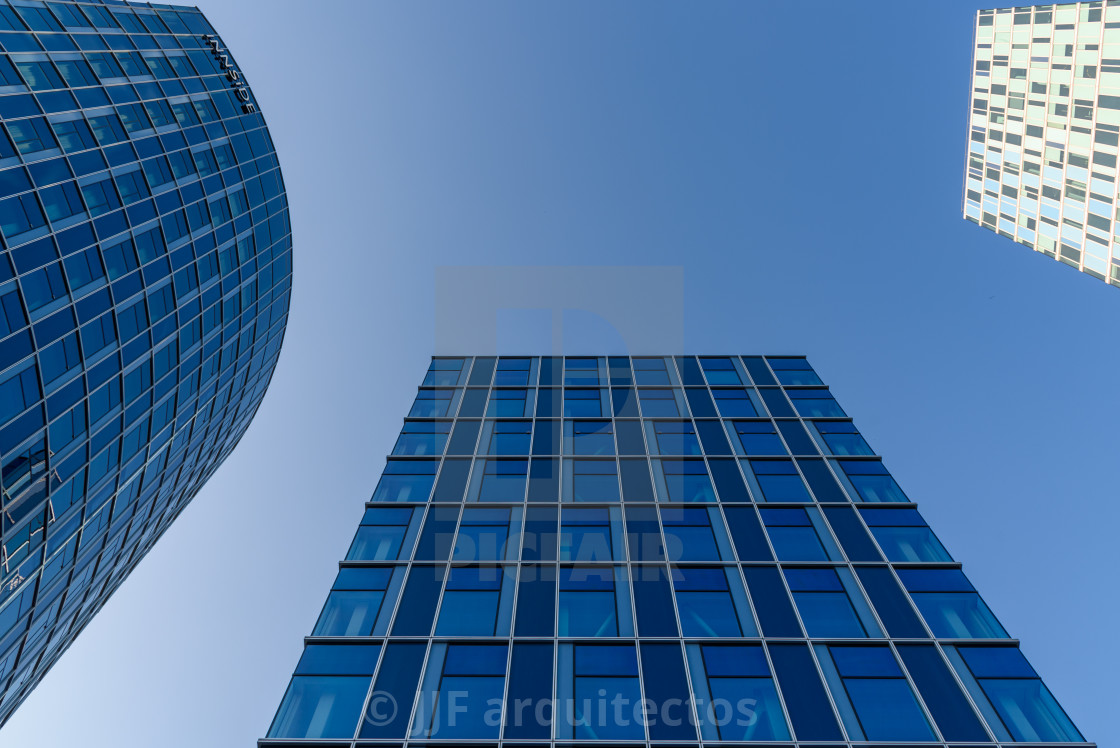 "Low angle view of modern office buildings against sky in Amsterdam" stock image