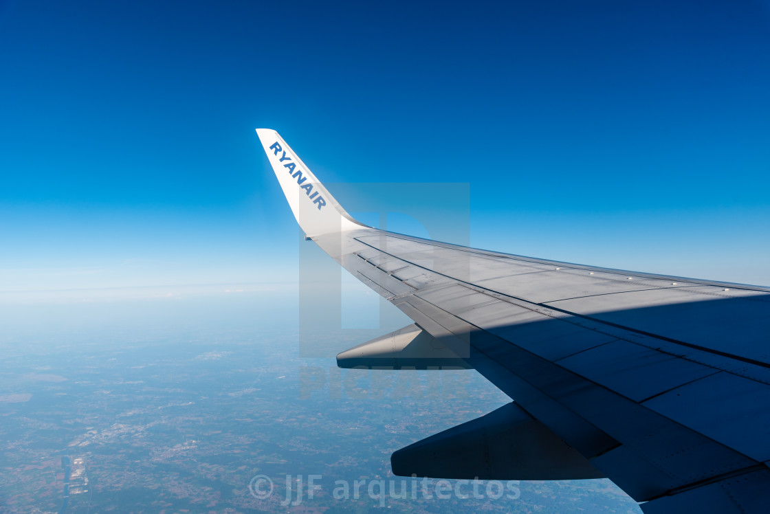 "Ryanair Boeing 737-800 wing. Mid-air shot through the window" stock image