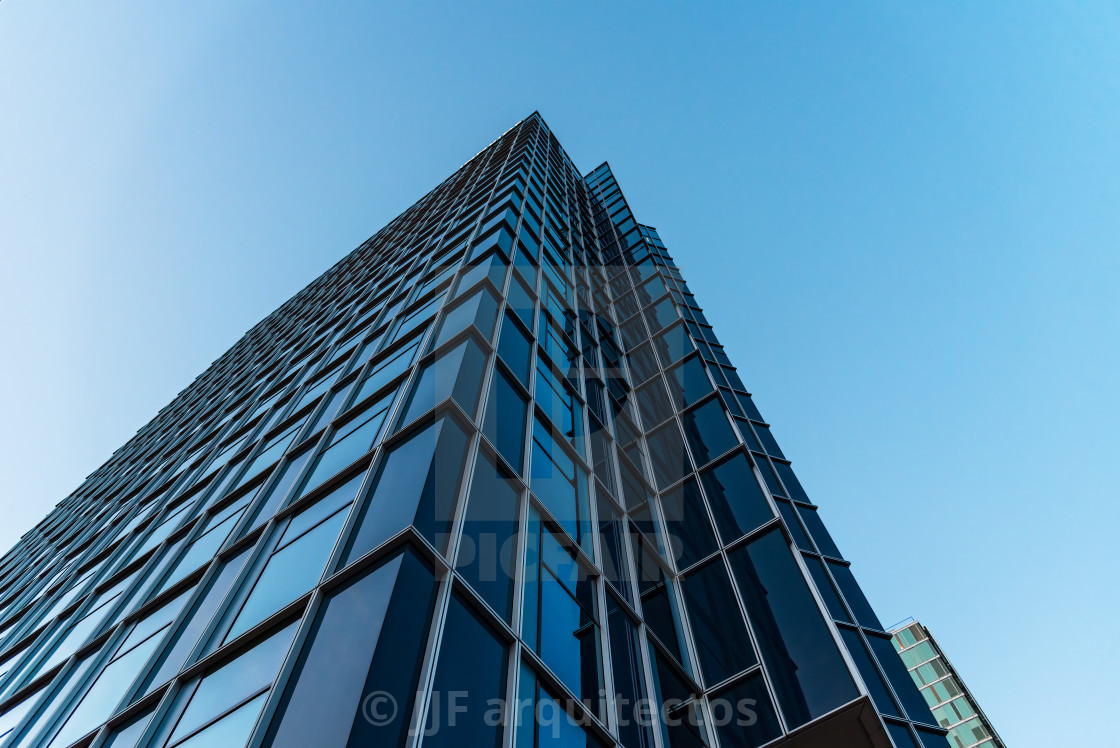 "Low angle view of blue skyscraper against sky in Amsterdam" stock image