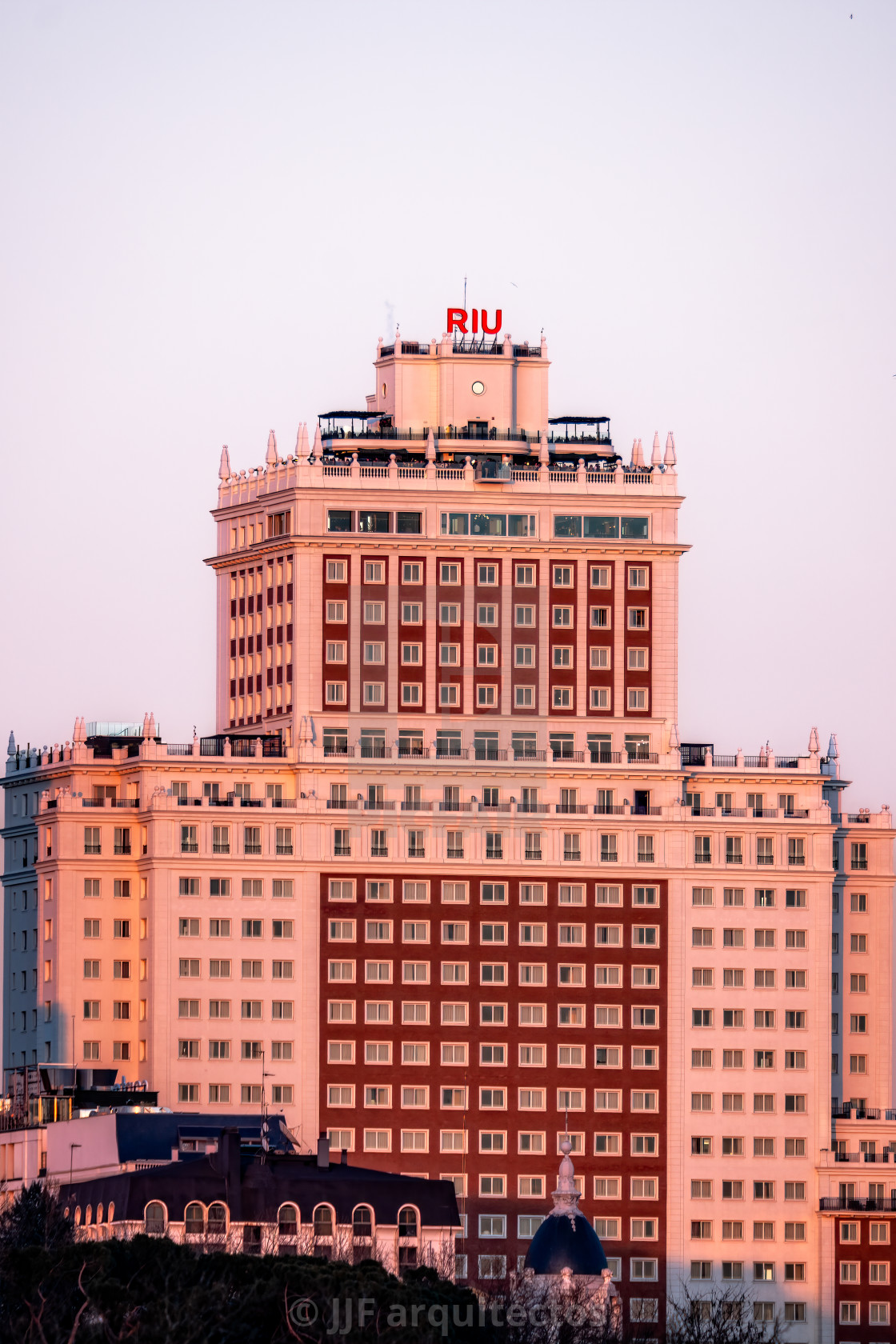 "Telephoto lens view of the Hotel Riu Plaza Espana at sunset" stock image