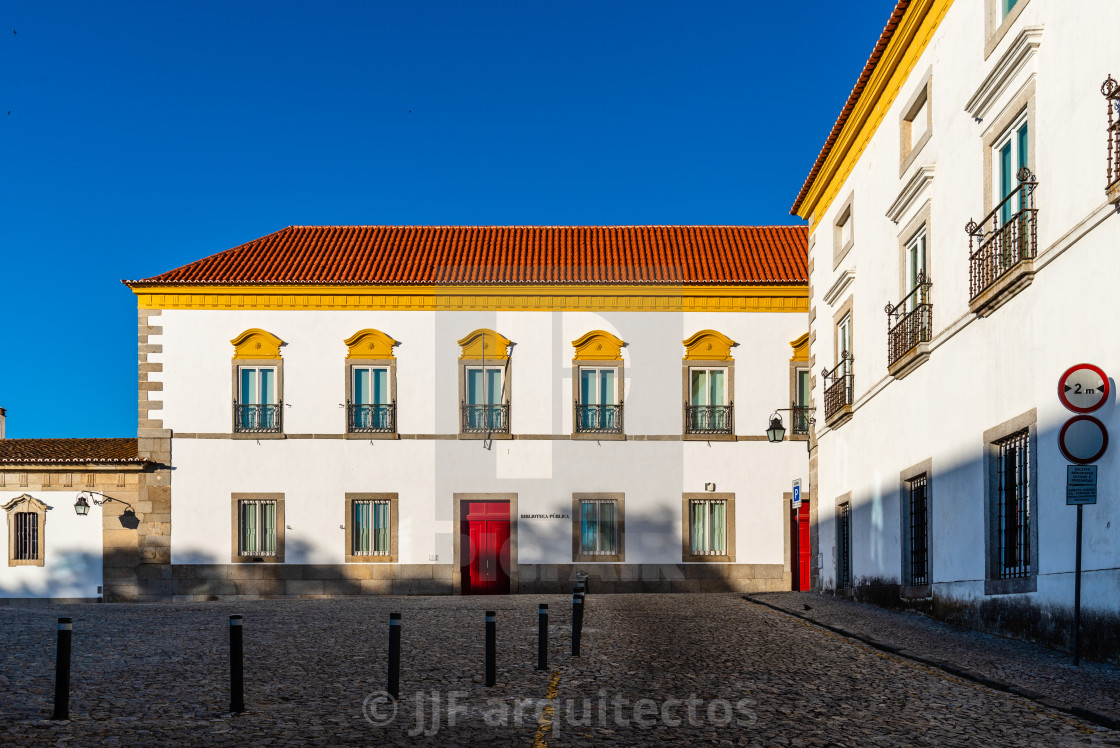 "Pousada hotel convent in the old town of Evora with buildings painted in white and yellow and ceramic tiled roofs" stock image