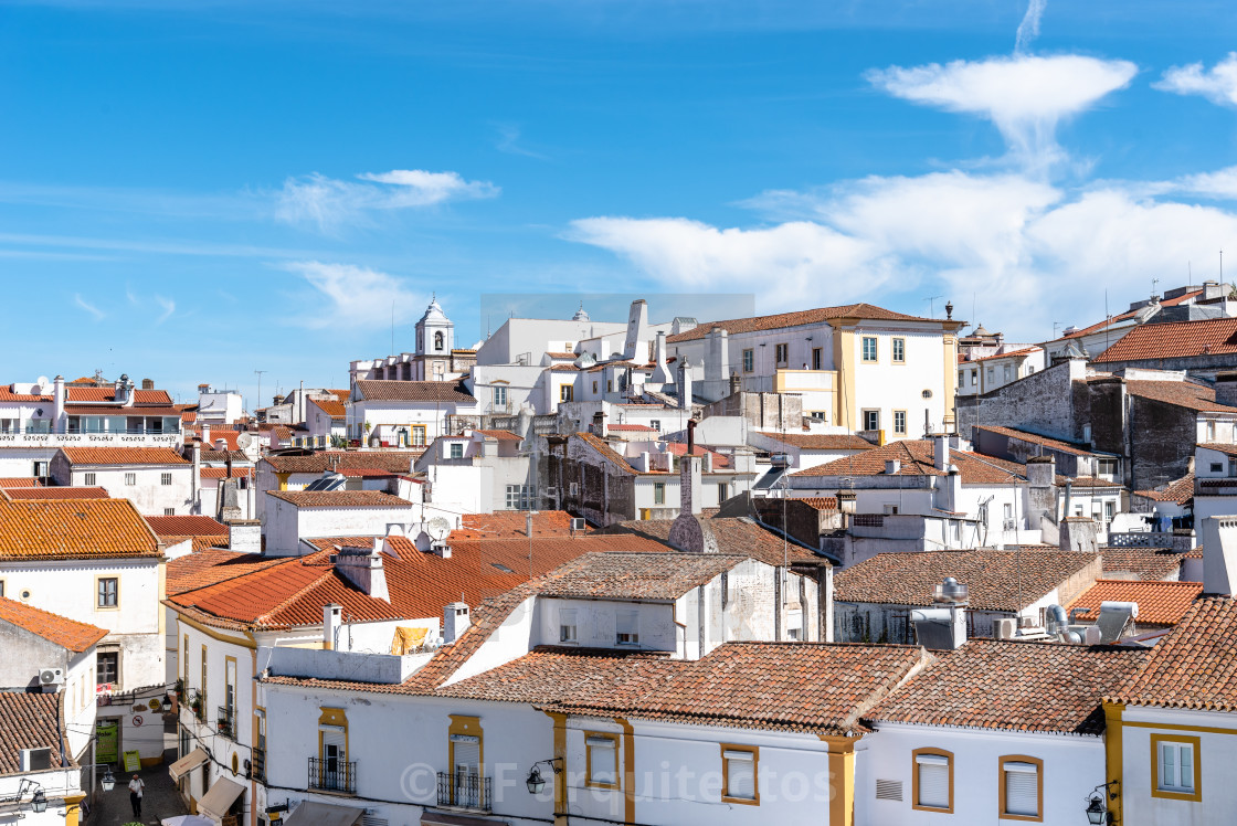 "Cityscape of Evora with typical houses painted in white and ceramic tiled roofs" stock image