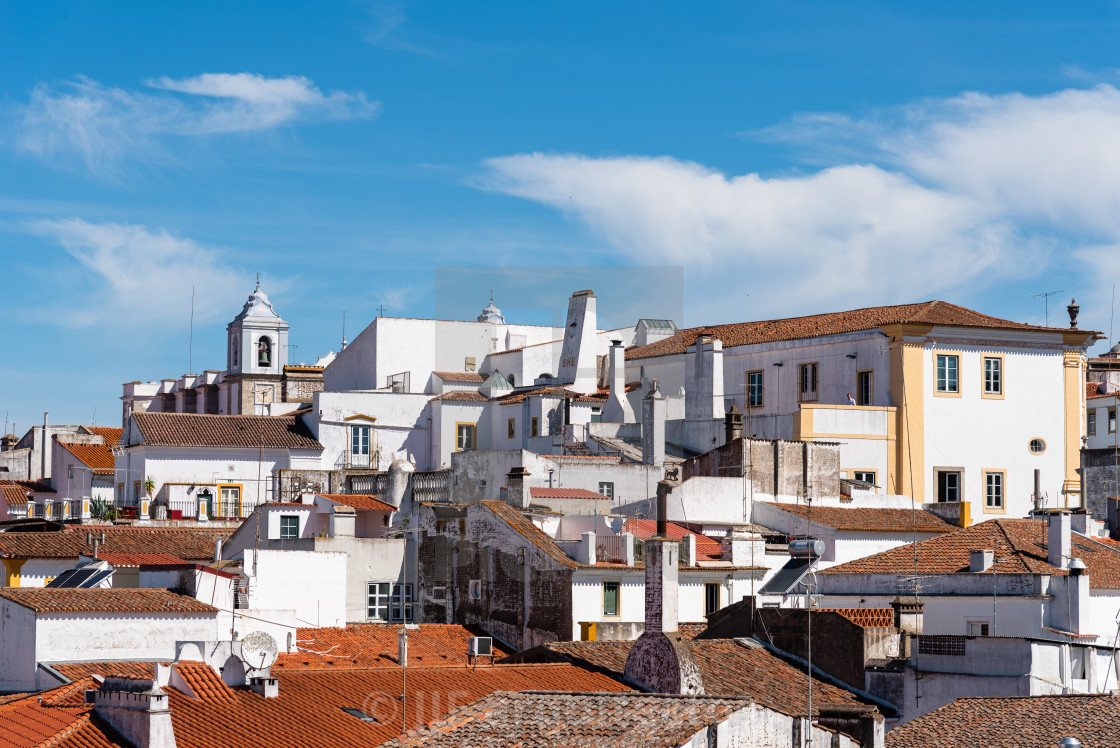 "Cityscape of Evora with typical houses painted in white and ceramic tiled roofs" stock image