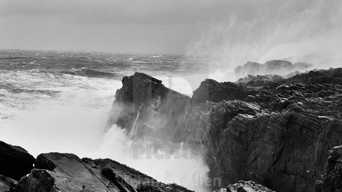 "Dún na mBó, waves hitting the cliffs" stock image