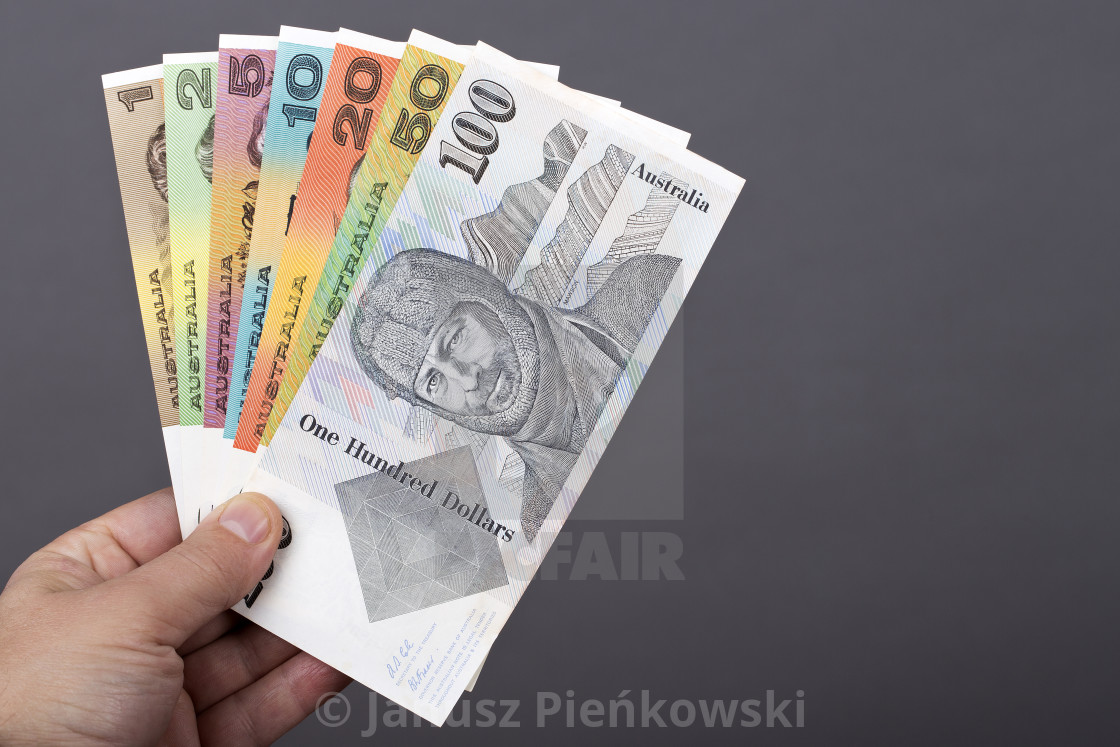 "Old Australian money in the hand on a gray background" stock image